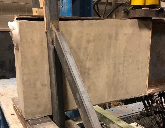 An image of a Reinforced Concrete slab standing vertically on its side.